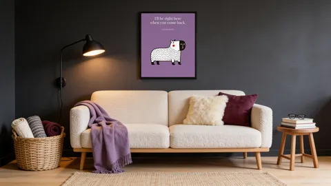 A loveseat under the framed Capy print I'll be right here when you come back, on a dark grey wall