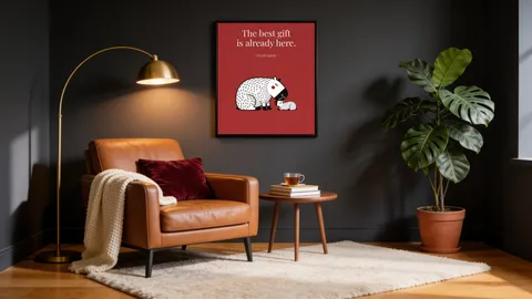 A reading nook with a dark grey wall, a leather armchair and the framed Capy and Bara print The best gift is already here