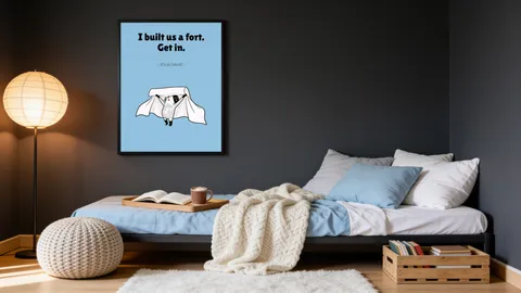 A daybed under the framed Bara print I built us a fort. Get in., on a dark grey wall